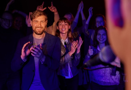 Man and Women clapping at a show