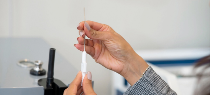 Audiologist holding a tool ready for ear wax removal