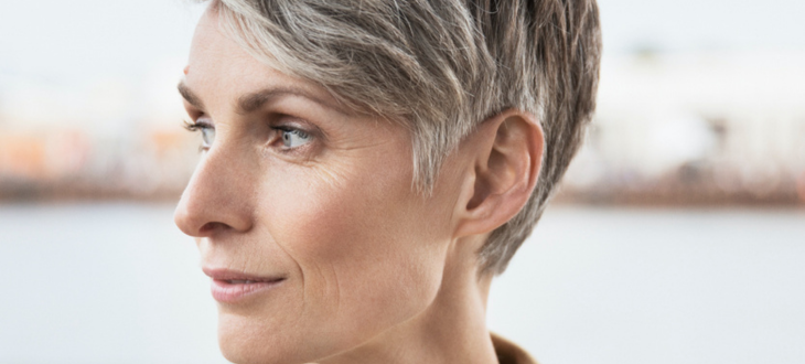 Older woman turning to the left with a close up of her ear