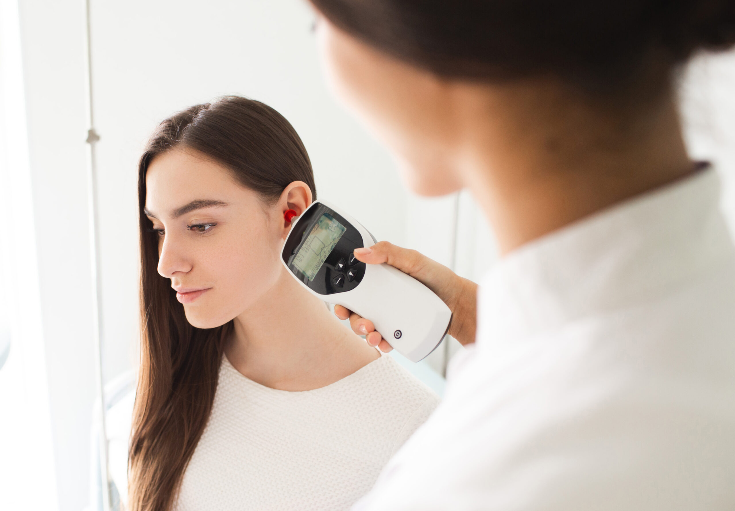 Woman having hearing test done by audiologist